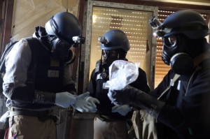 U.N. chemical weapons expert holding a plastic bag containing samples from one of the sites of an alleged chemical weapons 