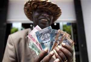 165002-a-man-from-south-sudan-displays-new-currency-notes-outside-the-central