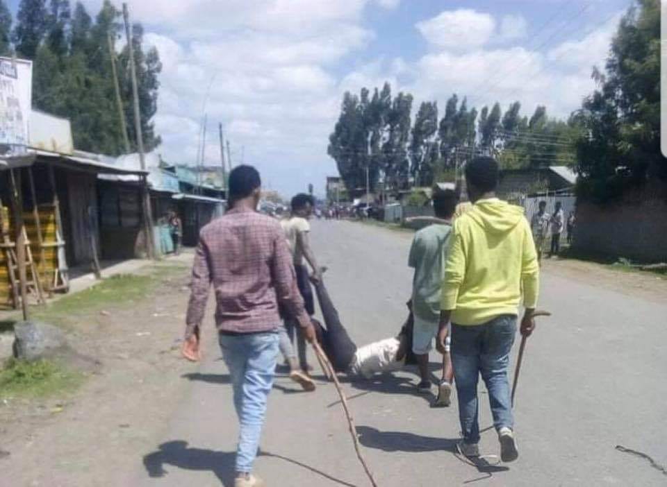 Jawar supporters drag their victim on a street after killing him