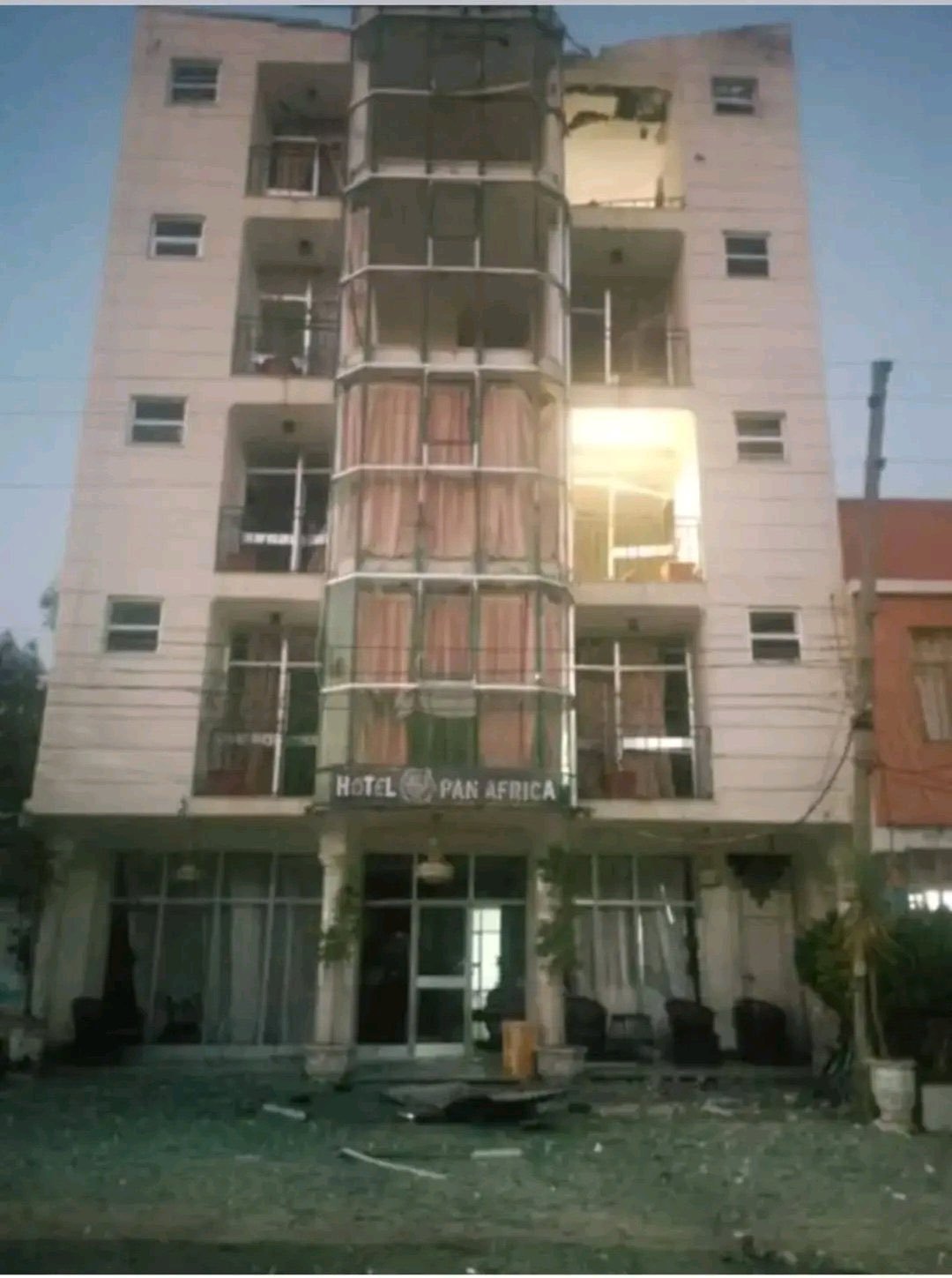 The Pan Africa Hotel in Adwa with blown-out windows and debris in front