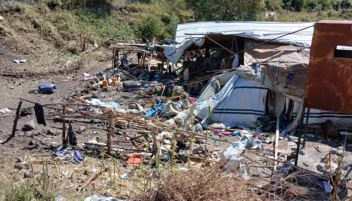 Torn tarpaulin shelters, broken poles and scattered belongings on a hillside at the Jari camp for displaced people near Hayk, South Wollo.